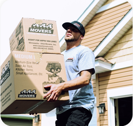 Man carrying moving boxes out of a home