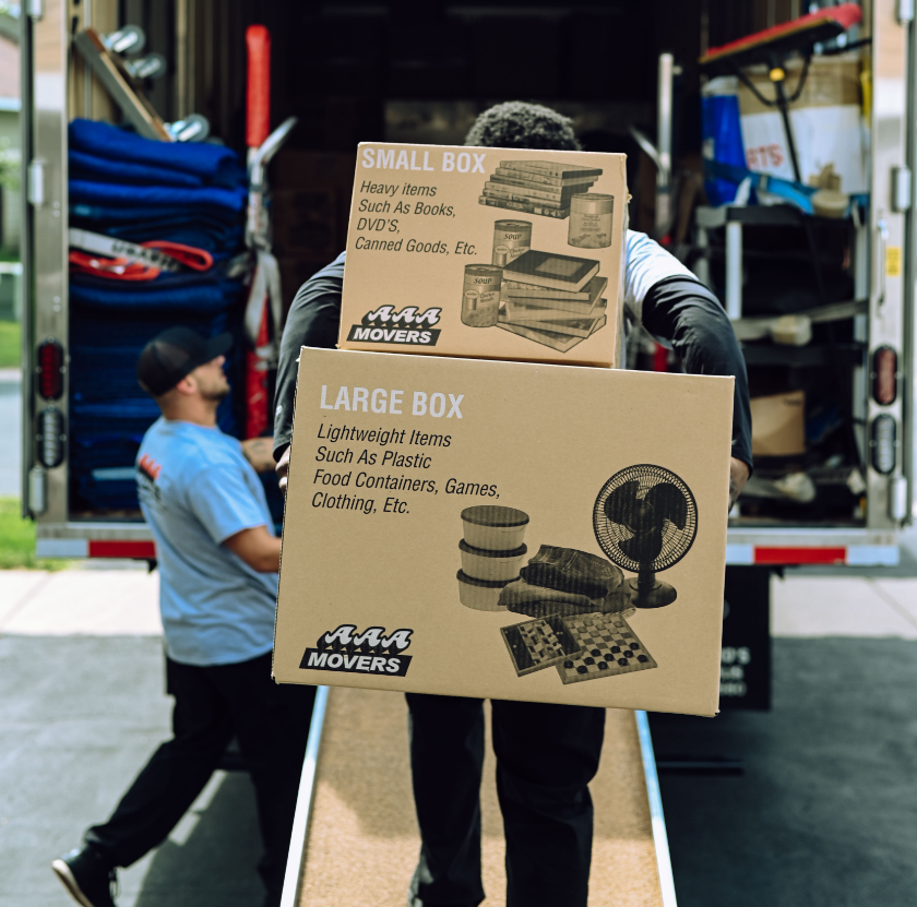 Person carrying moving boxes out from a moving truck