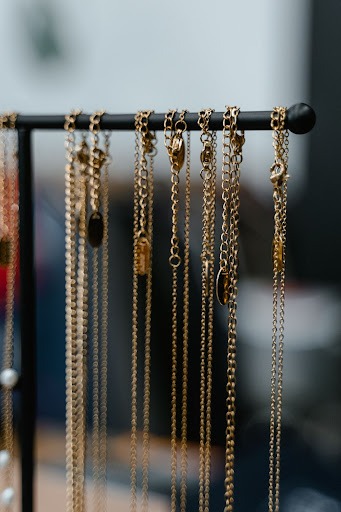 Necklaces hanging side by side. Packing jewelry correctly keeps them from getting tangled.