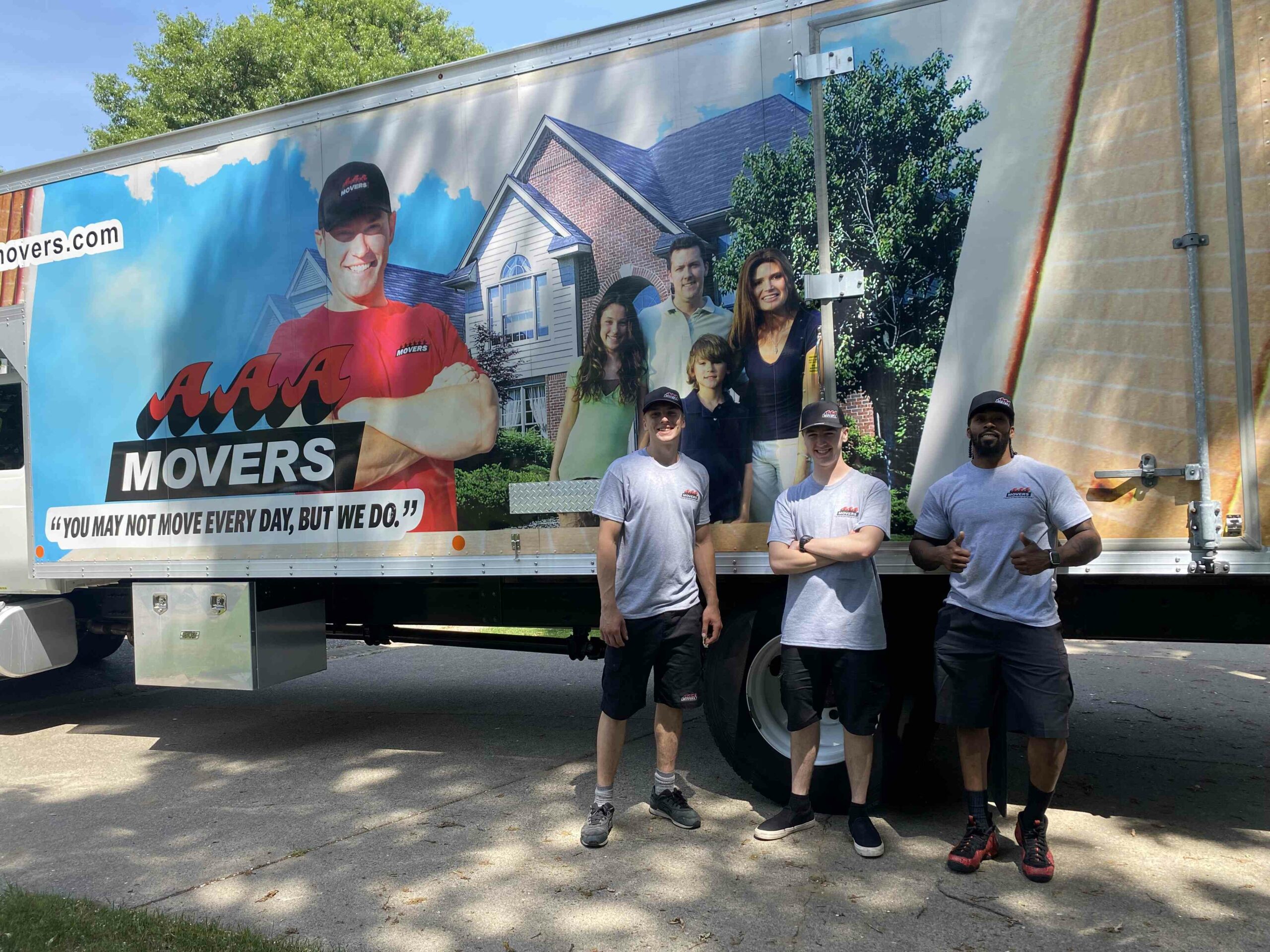 AAA Movers moving crew posing in front of their moving truck