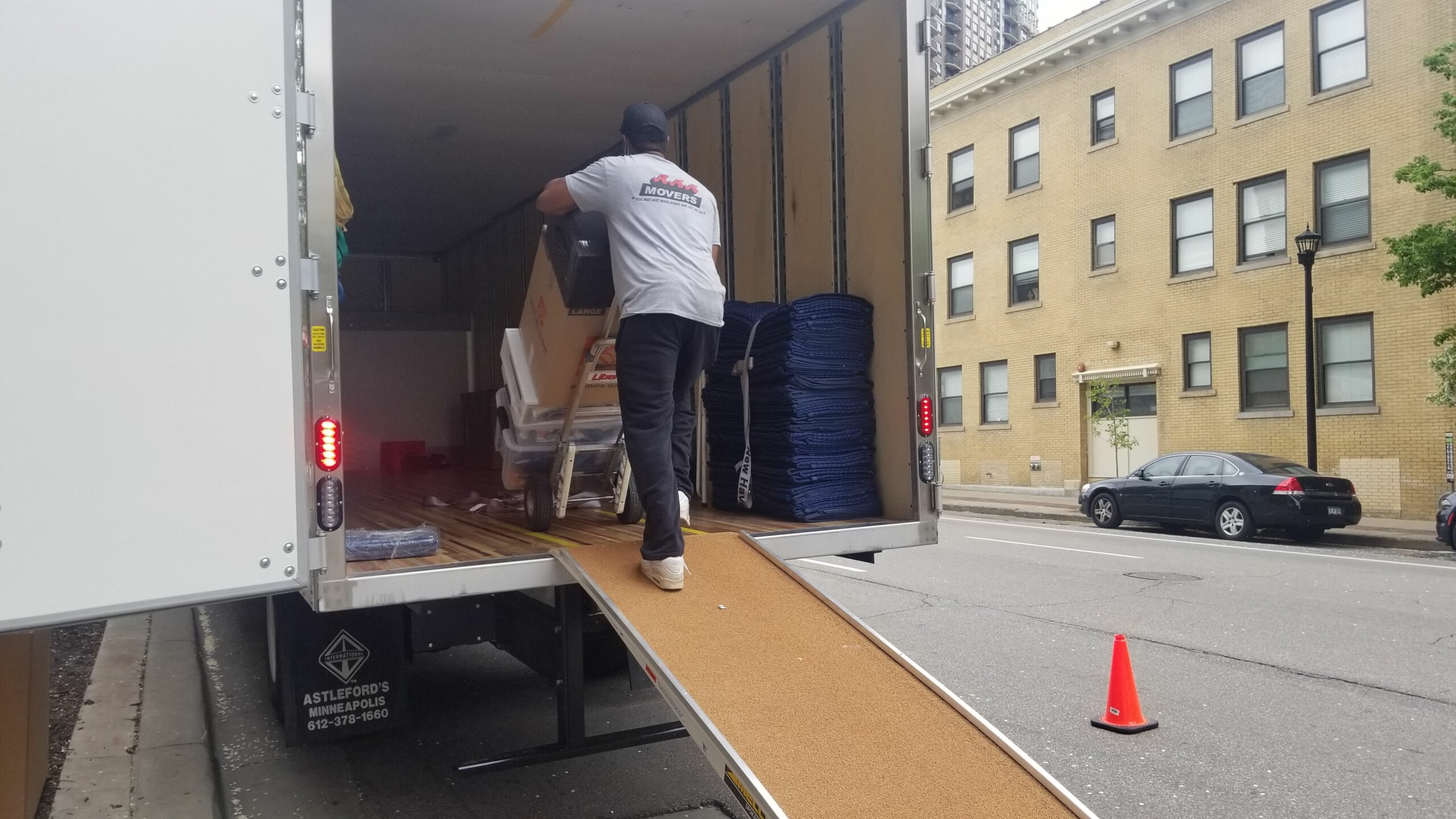 Mover in the back of a moving truck with a full dolley